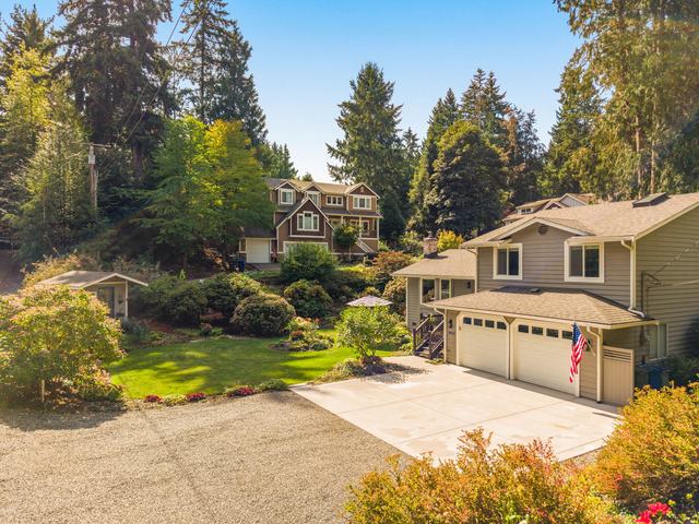 The front elevation and the garden beds along the drive