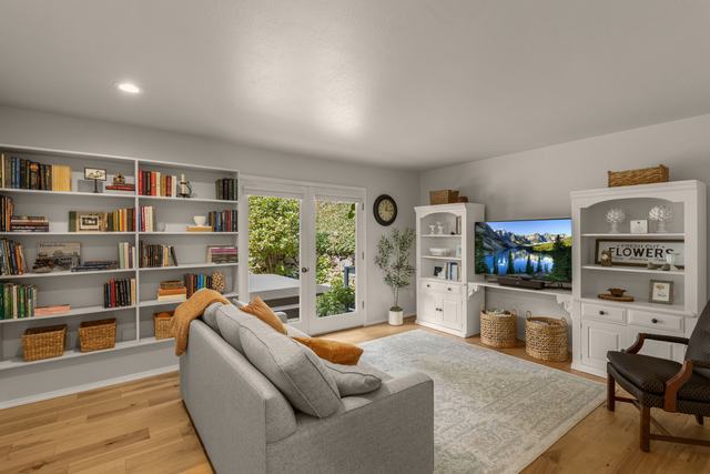 Living room, built-in shelving either side of the window