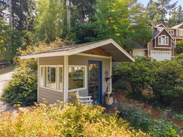 The detached studio at the edge of the lawn